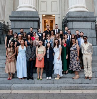 A group of 32 of the 2025 LAF Olmsted Scholars on the steps leading up to Gallier Hall