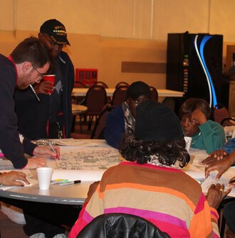 Community members gather and add ideas to a neighborhood plan