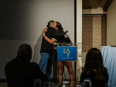 Randy Hester and Kendra Hyson hug during the Awards Dinner