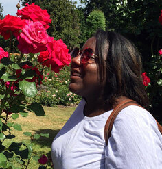 Jescelle smelling roses in a garden