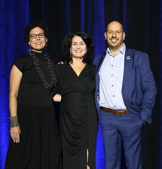 Alma Du Solier, Barbara Deutsch, and Michael Grove pose on stage